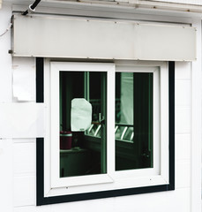 A white shop signage mockup above a shop window