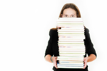 Beautiful girl holding a large number of books on an isolated white background