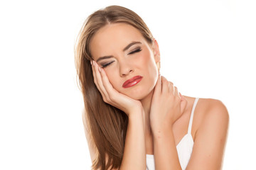 Fototapeta premium Beautiful girl with tootache on white background