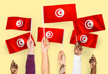 Hands waving the flags of Tunisia