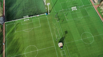 Aerial image over artificial grass football pitches. Long shadows thrown by a low sun. © TreasureGalore