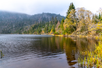Fototapeta premium Plesne Lake and Plechy Mountain in autumn. Sumava National Park, Czech Republic.
