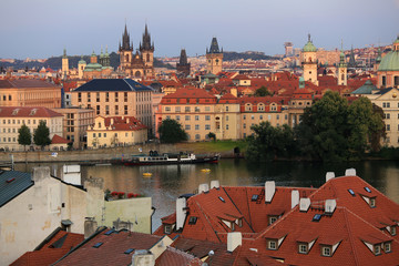 Obraz premium Prague, Czech Republic, September 19, 2018. Beautiful view from above on the city, red roofs of houses, the Vltava River and the Church of the Virgin Mary