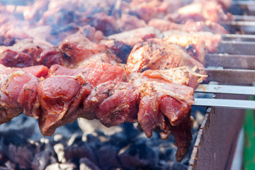 Grilled kebab cooking on metal skewer. Roasted meat cooked at barbecue