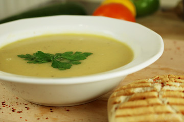 Cream soup with lentil with parsley and fresh bread