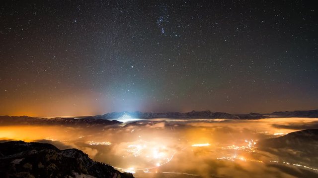 Light Pollution - Time Lapse - Stars / Milky way moving above fog filled with light pollution