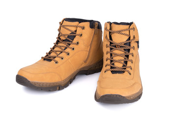 Two brown leather hiking boots or shoes isolated on white background.
