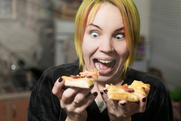 Shocked woman with mad eyes bites pizza.