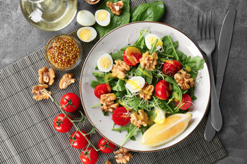 Delicious fresh salad with walnuts on plate