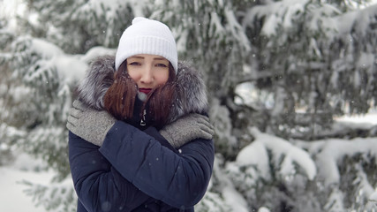 Fototapeta premium Young woman freezes for a walk in the forest.