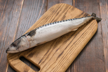 Mackerel fish on wooden background.