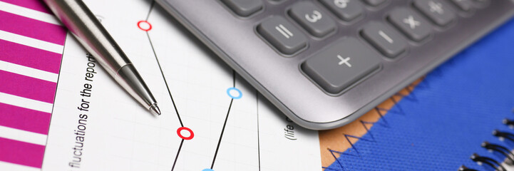 Silver calculator and financial statistics on clipboard