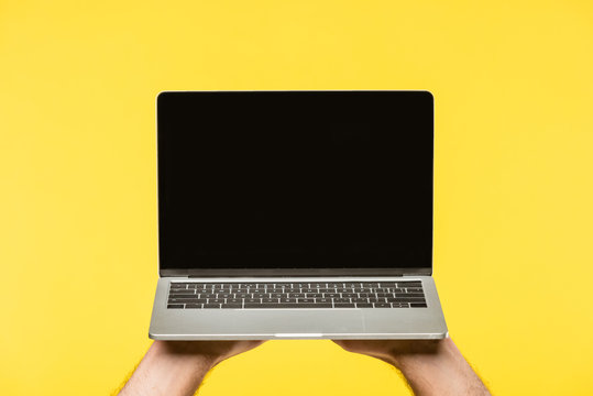 Cropped Shot Of Person Holding Laptop With Blank Screen Isolated On Yellow