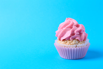 Tasty cupcake on color background