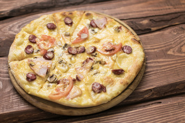 Pizza on a dark wooden background.