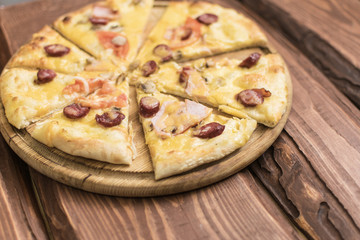 Pizza on a dark wooden background.