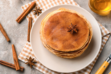 Plate with delicious homemade pancakes on table