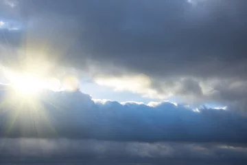 Fotobehang Hemel Rays of light shining through dark clouds, dramatic sky with cloud.