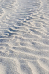 Dettail of the dunes and waves on the sand