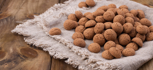 Dutch holiday Sinterklaas background with kruidnoten, pepernoten, traditional sweets, strooigoed. wooden background and free space for text. Flat lay with copy space. St. Nicolas day concept.