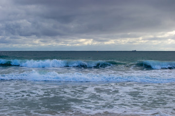 Landscape of a beach in north perth in a windy day full of waves water