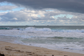 Landscape of a beach in north perth in a windy day full of waves water