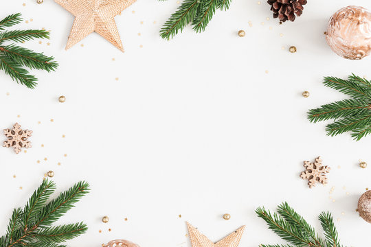 Christmas composition. Fir tree branches, golden decorations on pastel gray background. Christmas, winter, new year concept. Flat lay, top view, copy space
