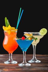 Alcoholic and non alcoholic cocktails on wooden table. Summer cold drinks