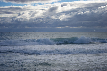 Landscape of a beach in north perth in a windy day full of waves water
