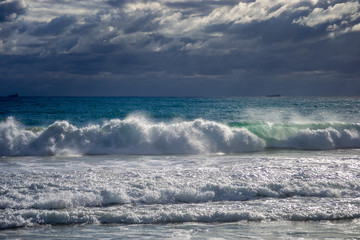 Landscape of a beach in north perth in a windy day full of waves water