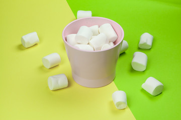 sweet marshmallow, candy on green background, top view