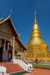 Fototapeta na wymiar Wat Phra That Hariphunchai The province Lampoon of Thailand. There is a statue of Kruba Srichai in the temple.The temple has a golden pagoda. And green lawns. And the beautiful temple gazebo.