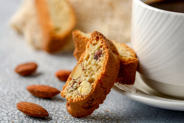 Good morning concept - breakfast frothy espresso coffee accompanied by delicious Italian almond cantuccini biscuits