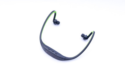 Wireless headphones closeup on white background with selective focus and crop fragme
