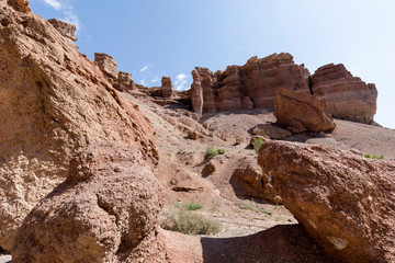 Views within the Charyn Canyon to the reddish sandstone cliffs. The canyon is also called valley of castles and is located east of Almaty in Kazakhstan.