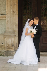 Happy newlyweds spend time together in their wedding day. Groom and bride