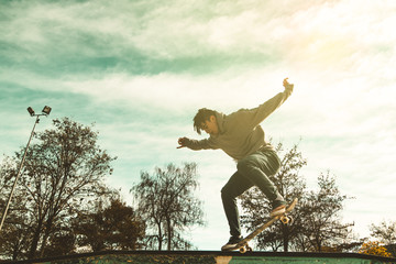 Guy practicing skateboarding and doing tricks in a skatepark