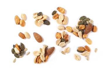 Healthy food mix of salted and spicy peanuts, sunflower and pumpkin seeds, almonds isolated on white background, top view