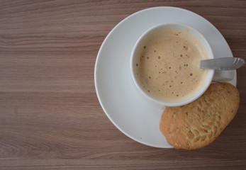 Cup of coffee on a textured Board.