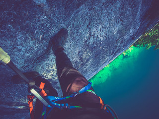 climber looks down at climbing on a steep wall, Via ferrata