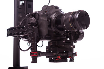 System stabilization video camera and lens on steady equipment support such as gimbal steady or stabilized. White background