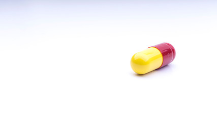 Medicine pills or capsules closeup on a white background with selective focus and crop fragment
