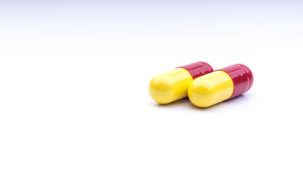 Medicine pills or capsules closeup on a white background with selective focus and crop fragment