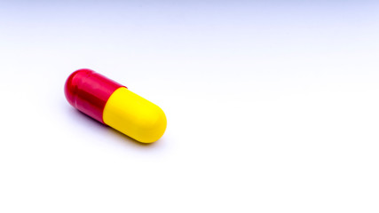 Medicine pills or capsules closeup on a white background with selective focus and crop fragment