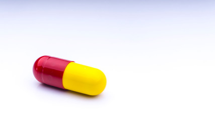 Medicine pills or capsules closeup on a white background with selective focus and crop fragment
