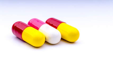 Medicine pills or capsules closeup on a white background with selective focus and crop fragment