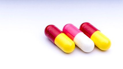 Medicine pills or capsules closeup on a white background with selective focus and crop fragment
