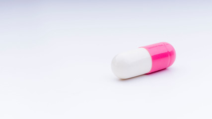 Medicine pills or capsules closeup on a white background with selective focus and crop fragment