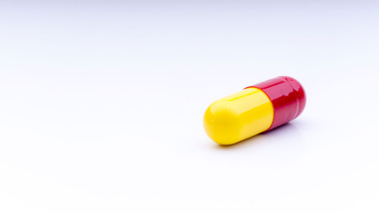 Medicine pills or capsules closeup on a white background with selective focus and crop fragment