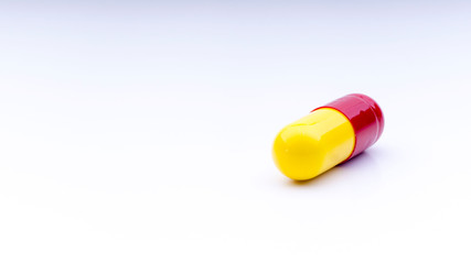 Medicine pills or capsules closeup on a white background with selective focus and crop fragment